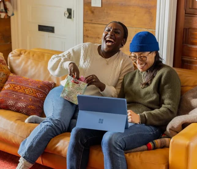 Two Cashew Collective panelists laughing while taking a study together